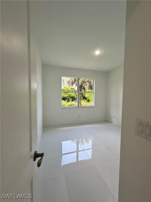 718 Chattman St E, Lehigh Acres, FL 33974 - unfurnished room with tile patterned floors and recessed lighting