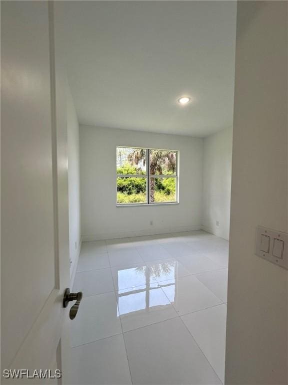 718 Chattman St E, Lehigh Acres, FL 33974 - tiled spare room with recessed lighting and baseboards
