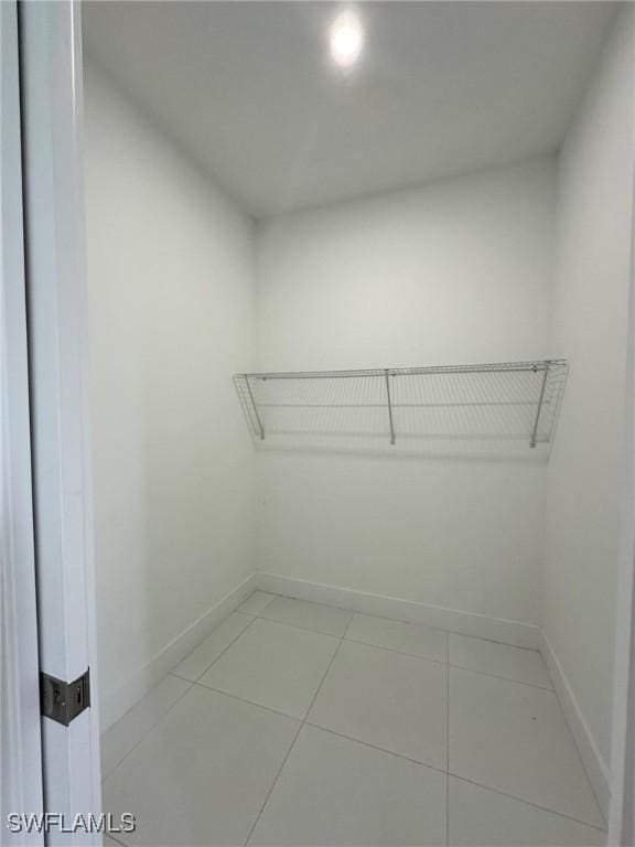 718 Chattman St E, Lehigh Acres, FL 33974 - walk in closet featuring tile patterned floors