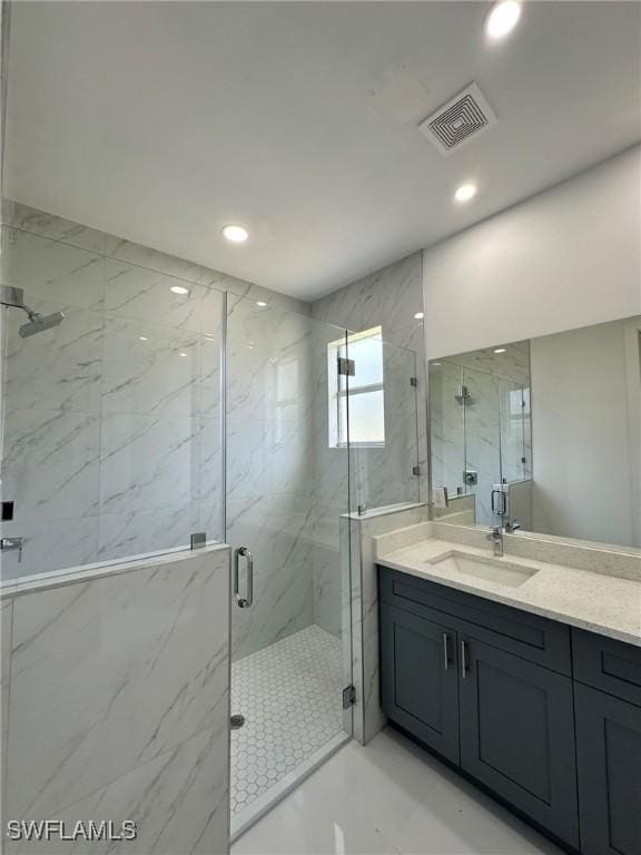 718 Chattman St E, Lehigh Acres, FL 33974 - bathroom featuring a marble finish shower, vanity, and recessed lighting