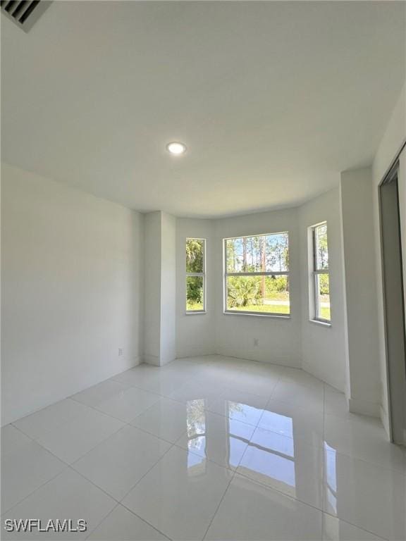 718 Chattman St E, Lehigh Acres, FL 33974 - empty room with recessed lighting and tile patterned flooring