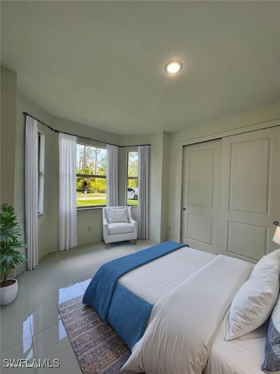 718 Chattman St E, Lehigh Acres, FL 33974 - bedroom with tile patterned flooring, a closet, and recessed lighting
