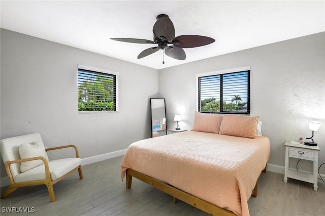 387 S Heathwood Dr, Marco Island, FL 34145 - bedroom featuring multiple windows, light wood-style flooring, and baseboards