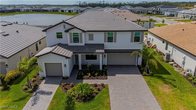 18707 Ivywood Pl, Estero, FL 33928 - view of front of property featuring central AC, a front yard, a residential view, and decorative driveway