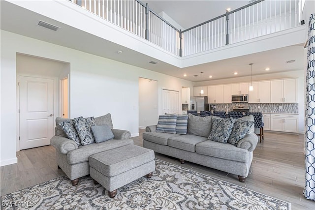 18707 Ivywood Pl, Estero, FL 33928 - living room featuring light wood-type flooring, baseboards, and visible vents