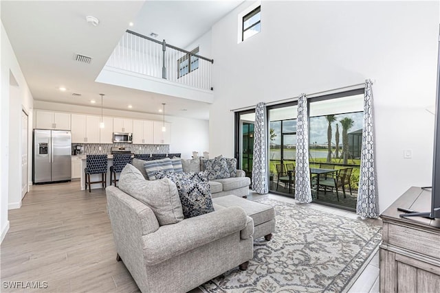 18707 Ivywood Pl, Estero, FL 33928 - living area with light wood-type flooring, a healthy amount of sunlight, visible vents, and recessed lighting