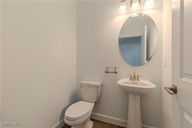 18707 Ivywood Pl, Estero, FL 33928 - bathroom featuring toilet, baseboards, and a sink
