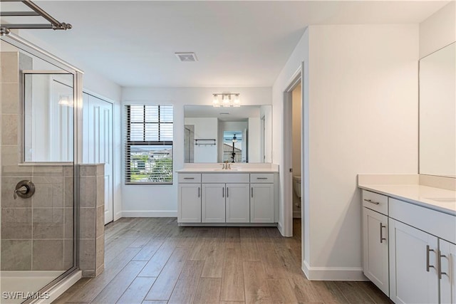 18707 Ivywood Pl, Estero, FL 33928 - full bath with a stall shower, wood finished floors, a sink, and visible vents