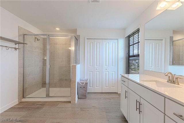 18707 Ivywood Pl, Estero, FL 33928 - bathroom with a shower stall, vanity, and wood finish floors