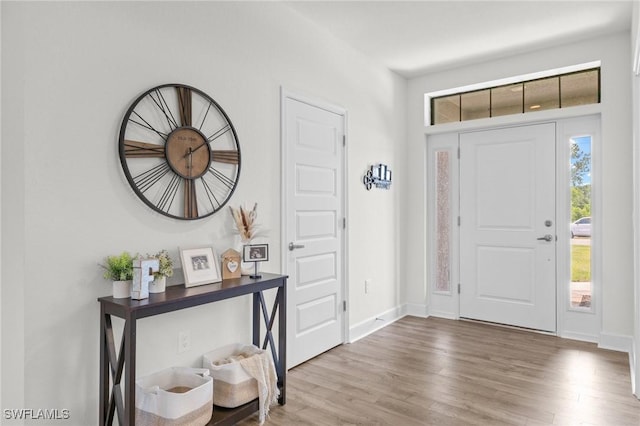490 Windermere Dr, Lehigh Acres, FL 33972 - entryway with baseboards and wood finished floors