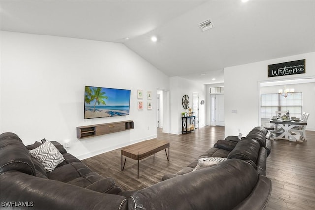 490 Windermere Dr, Lehigh Acres, FL 33972 - living area with vaulted ceiling, baseboards, a chandelier, visible vents, and wood finished floors