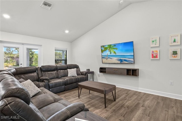 490 Windermere Dr, Lehigh Acres, FL 33972 - living room featuring lofted ceiling, french doors, baseboards, visible vents, and wood finished floors
