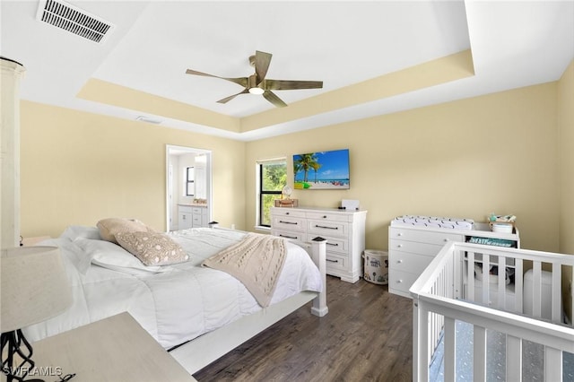 490 Windermere Dr, Lehigh Acres, FL 33972 - bedroom featuring dark wood finished floors, visible vents, a ceiling fan, and a raised ceiling