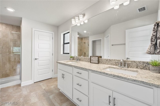 490 Windermere Dr, Lehigh Acres, FL 33972 - full bathroom with a sink, double vanity, visible vents, and a shower stall
