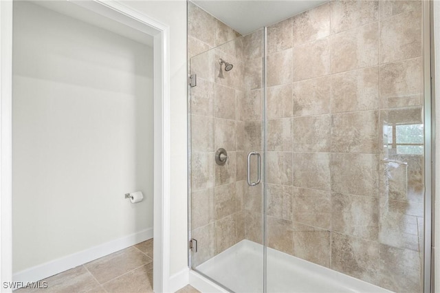 490 Windermere Dr, Lehigh Acres, FL 33972 - bathroom featuring tile patterned flooring, a stall shower, and baseboards