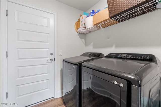 490 Windermere Dr, Lehigh Acres, FL 33972 - laundry area featuring independent washer and dryer, wood finished floors, and laundry area