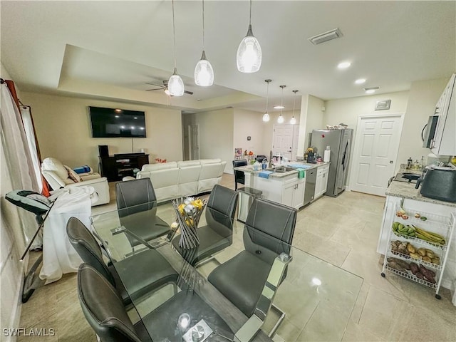 dining area with visible vents, recessed lighting, ceiling fan, and a tray ceiling