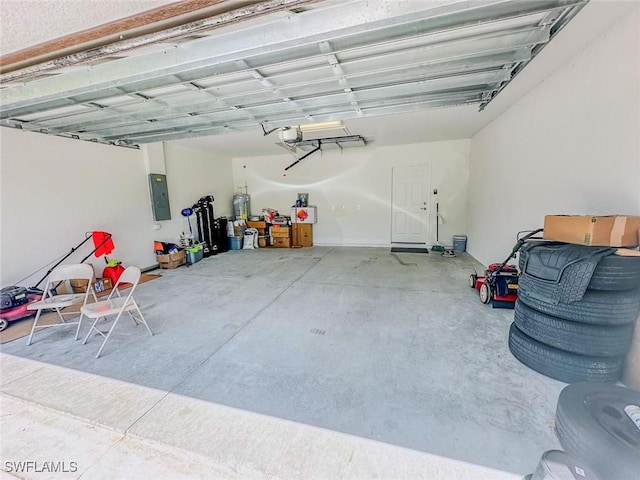 garage with a garage door opener and electric panel