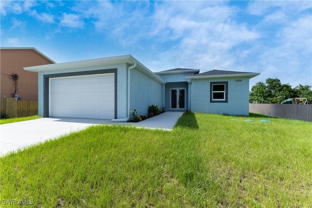5308 4th St W, Lehigh Acres, FL 33971 - view of front of home with french doors, concrete driveway, stucco siding, and an attached garage