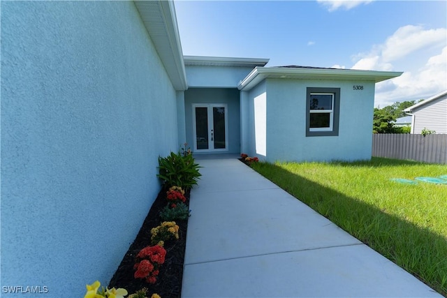 5308 4th St W, Lehigh Acres, FL 33971 - view of exterior entry featuring french doors and stucco siding