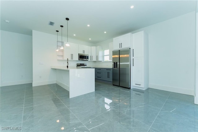 5308 4th St W, Lehigh Acres, FL 33971 - kitchen with stainless steel appliances, baseboards, a peninsula, light countertops, and recessed lighting