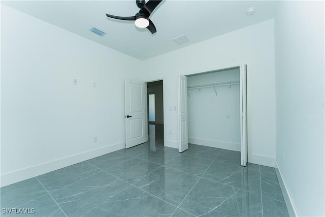 5308 4th St W, Lehigh Acres, FL 33971 - unfurnished bedroom featuring a closet, a ceiling fan, dark marble finish flooring, and baseboards