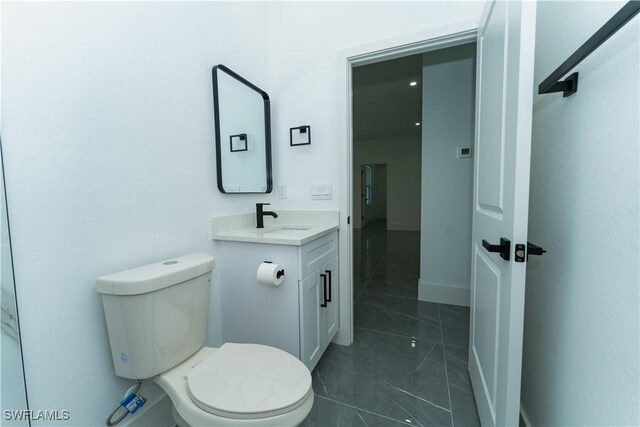 5308 4th St W, Lehigh Acres, FL 33971 - bathroom with vanity, toilet, and baseboards