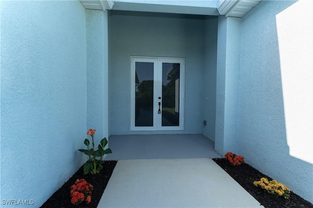 5308 4th St W, Lehigh Acres, FL 33971 - view of exterior entry featuring french doors and stucco siding