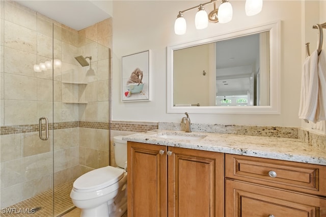 27549 Riverbank Dr, Bonita Springs, FL 34134 - full bath with toilet, tile walls, a stall shower, and vanity