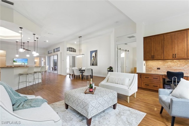 27549 Riverbank Dr, Bonita Springs, FL 34134 - living area with visible vents, baseboards, light wood-type flooring, and lofted ceiling