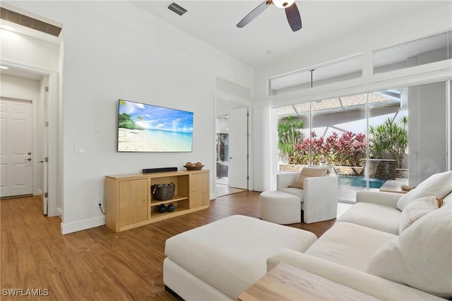 27549 Riverbank Dr, Bonita Springs, FL 34134 - living area with visible vents, baseboards, a high ceiling, a ceiling fan, and wood finished floors