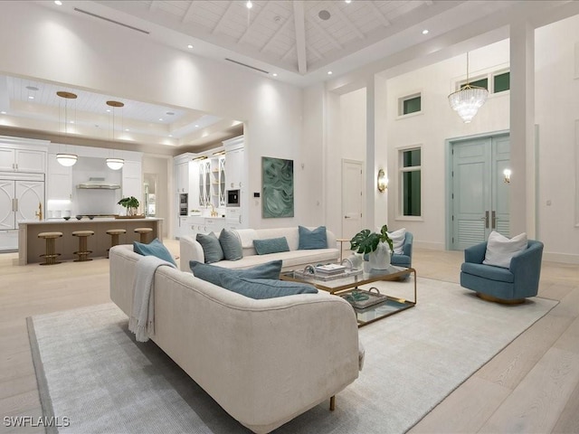 619 Binnacle Dr, Naples, FL 34103 - living room featuring a tray ceiling, light wood finished floors, a high ceiling, baseboards, and recessed lighting