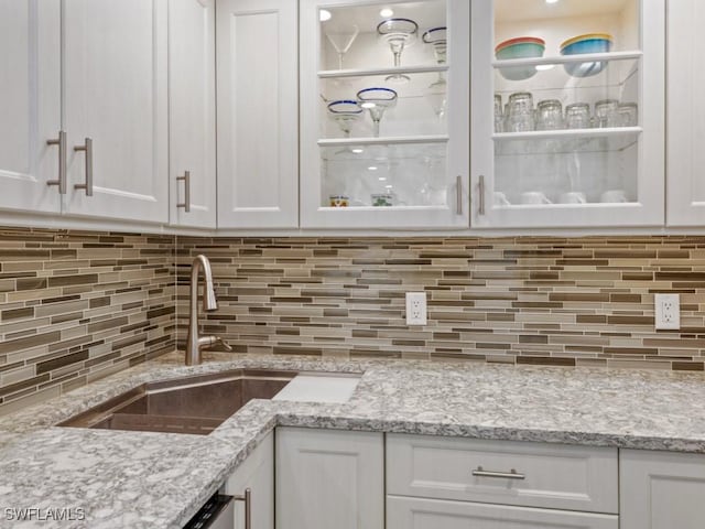140 Seaview Ct Unit 1703N, Marco Island, FL 34145 - kitchen featuring white cabinets, backsplash, and light stone counters