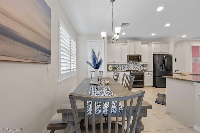 dining space featuring an inviting chandelier, light tile patterned floors, recessed lighting, and visible vents