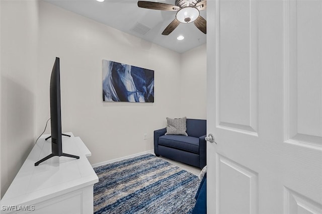 living area featuring baseboards, visible vents, recessed lighting, and a ceiling fan