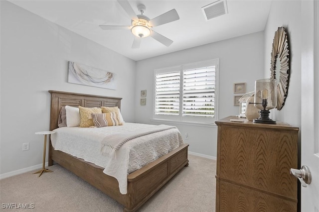 bedroom featuring baseboards, ceiling fan, visible vents, and light colored carpet