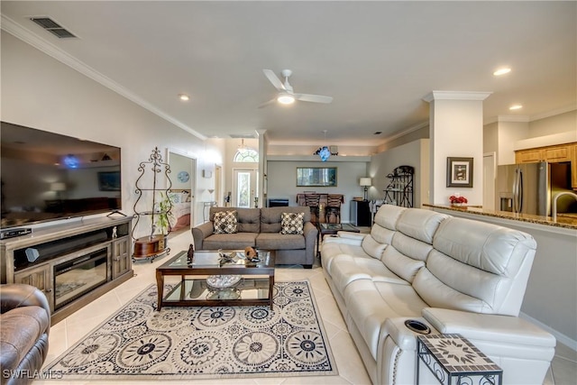 living area featuring visible vents, light tile patterned floors, ceiling fan, and crown molding