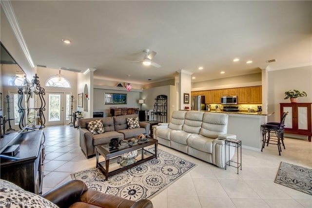 living area with light tile patterned floors, recessed lighting, and ornamental molding