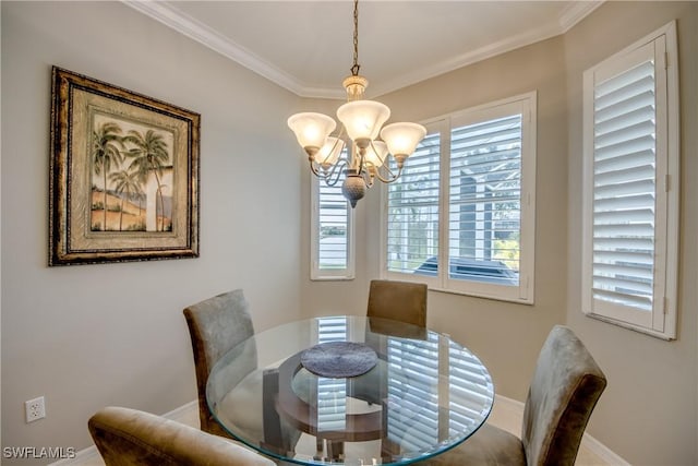 dining room with an inviting chandelier, ornamental molding, and baseboards