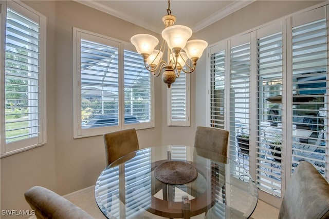 dining room featuring a wealth of natural light, crown molding, baseboards, and a notable chandelier