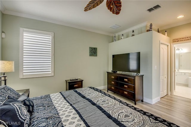 bedroom featuring baseboards, visible vents, wood finished floors, connected bathroom, and ornamental molding