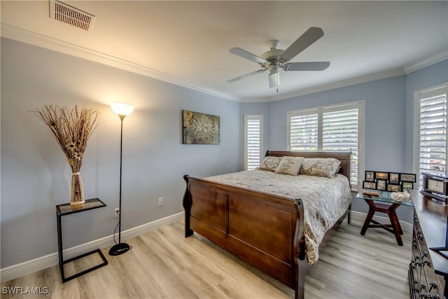 bedroom with light wood-type flooring, visible vents, and ornamental molding