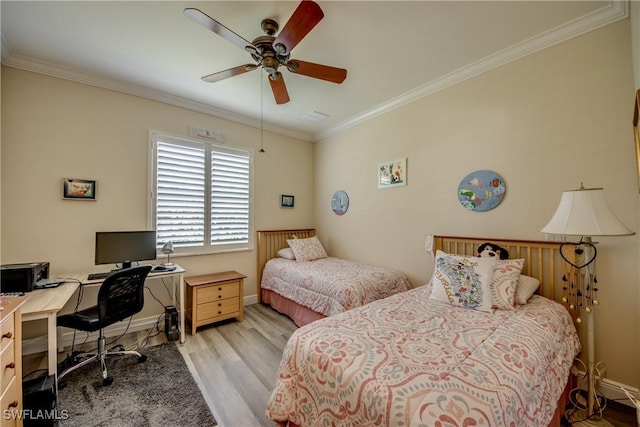 bedroom with a ceiling fan, baseboards, ornamental molding, and wood finished floors
