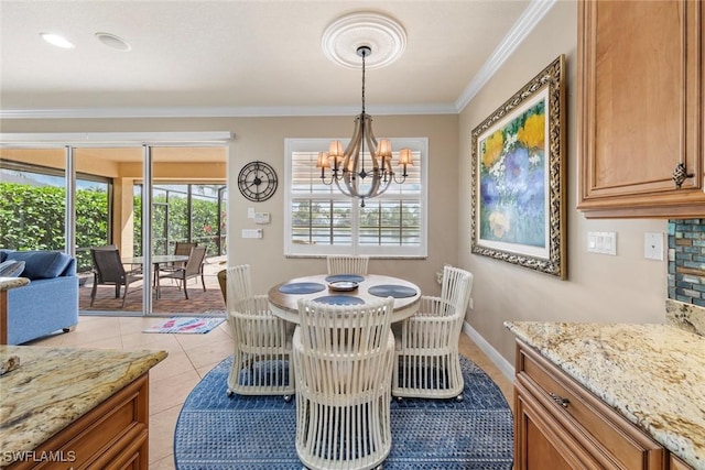 dining area with baseboards, crown molding, a chandelier, and light tile patterned floors