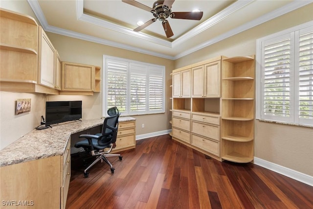 home office with dark wood finished floors, ceiling fan, ornamental molding, and a raised ceiling