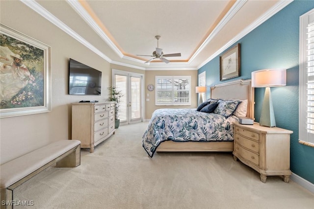 bedroom featuring a tray ceiling, access to exterior, crown molding, light carpet, and ceiling fan