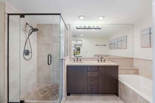 6025 Chardonnay Ln Unit 103, Naples, FL 34119 - bathroom featuring a bath, a sink, double vanity, and a stall shower