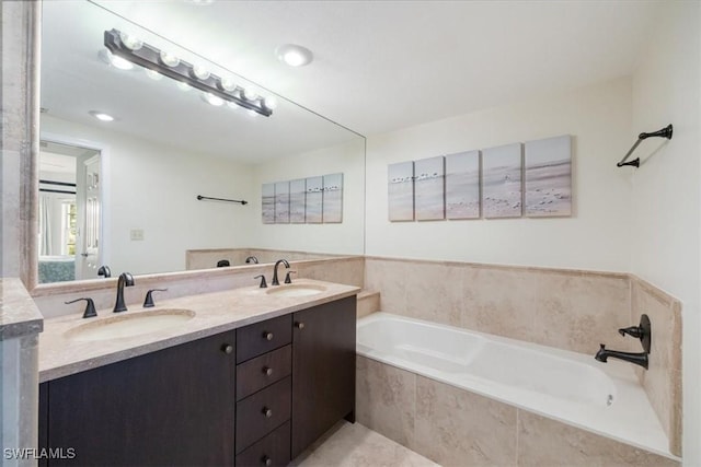 6025 Chardonnay Ln Unit 103, Naples, FL 34119 - full bathroom featuring a bath, a sink, and double vanity