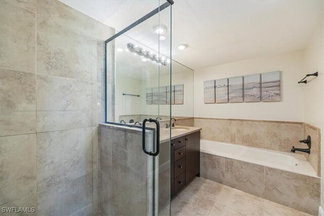 6025 Chardonnay Ln Unit 103, Naples, FL 34119 - bathroom featuring a garden tub, vanity, and a shower stall