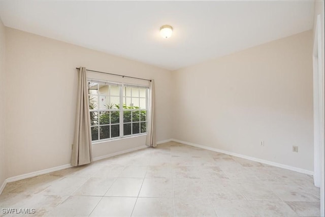 6025 Chardonnay Ln Unit 103, Naples, FL 34119 - unfurnished room featuring baseboards and light tile patterned floors